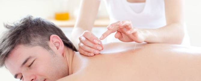 smiling young man in an acupuncture therapy